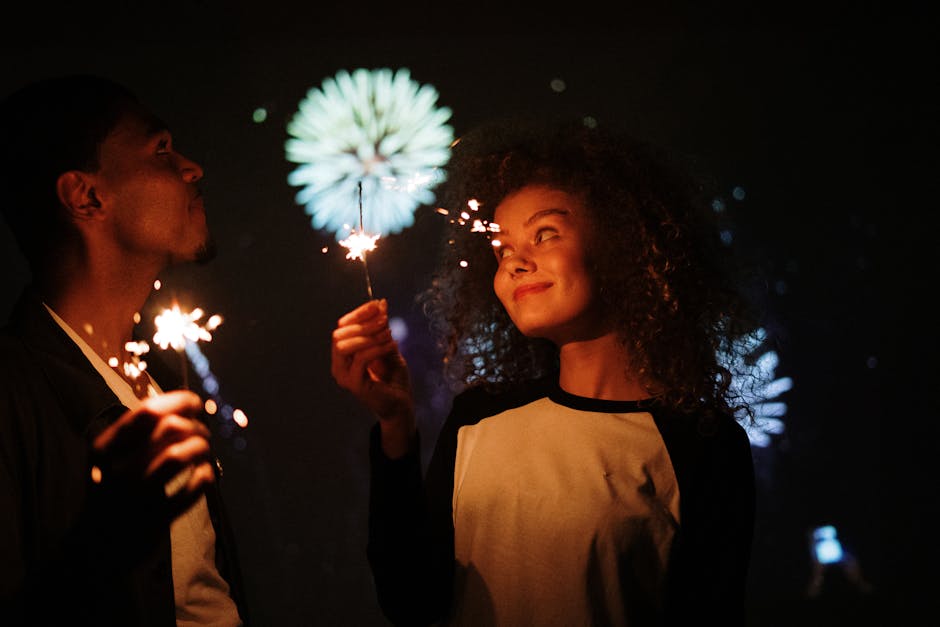 Couple celebrating with sparklers at night